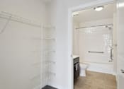 Thumbnail 29 of 33 - A white bathroom with a walk-in shower and toilet.