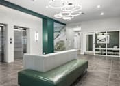 Thumbnail 15 of 23 - A white and green room with a bench and a glass wall.