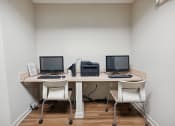 Thumbnail 9 of 17 - a desk with three computers and a printer on it