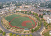 Thumbnail 17 of 17 - an aerial view of a baseball field with buildings in the background