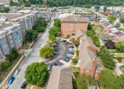 Thumbnail 4 of 17 - an aerial view of a city with buildings and parking lot