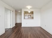 Thumbnail 5 of 26 - A room with wooden floors and white walls.