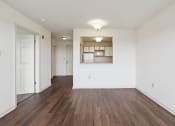 Thumbnail 12 of 17 - a bedroom with hardwood flooring and white walls