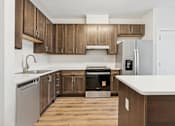 Thumbnail 3 of 23 - A kitchen with wooden cabinets and a white countertop.