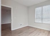 Thumbnail 3 of 25 - A room with a window and a door.