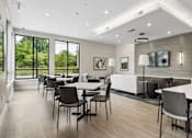 Thumbnail 9 of 23 - A modern dining room with a large table and chairs.