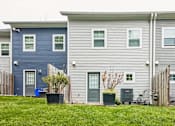 Thumbnail 12 of 18 - A row of houses with grey and blue siding.