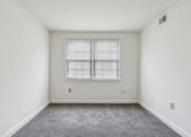 Thumbnail 16 of 17 - an empty room with white walls and a window