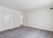 Thumbnail 17 of 17 - a bedroom with white walls and carpet and two doors