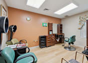 Thumbnail 7 of 21 - a treatment room with chairs and a desk
