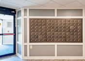 Thumbnail 28 of 75 - A wall of brown mailboxes in a hallway.