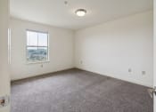 Thumbnail 11 of 17 - a bedroom with white walls and carpet