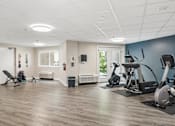 Thumbnail 34 of 75 - A spacious gym with a variety of exercise equipment.
