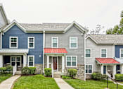 Thumbnail 7 of 18 - A row of houses with a red awning on the front door.