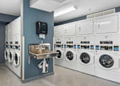Thumbnail 64 of 75 - A row of washing machines in a laundromat.