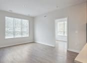 Thumbnail 13 of 25 - A spacious room with a window and a door.