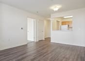 Thumbnail 27 of 30 - A room with wooden floors and white walls.