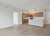 Thumbnail 8 of 25 - A kitchen with wooden cabinets and a white island.