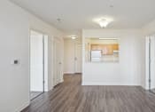 Thumbnail 17 of 26 - A room with white walls and wooden flooring with a window.
