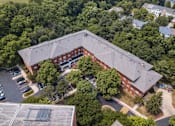 Thumbnail 2 of 18 - an aerial view of a red brick building with a grey roof