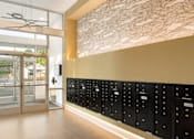 Thumbnail 5 of 24 - A row of mailboxes are lined up on a wall.