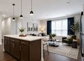 Thumbnail 22 of 25 - A modern kitchen with dark wood cabinets and a white island.