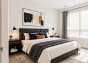 Thumbnail 24 of 25 - A modern bedroom with a large bed and a painting above it.