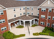 Thumbnail 17 of 19 - A large brick building with a courtyard in the middle.