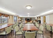 Thumbnail 5 of 18 - a large room with tables and chairs and a fireplace