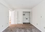 Thumbnail 17 of 21 - A room with white walls and a carpeted floor.