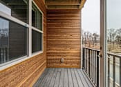 Thumbnail 8 of 17 - A wooden deck with a glass door and a window.