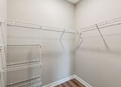Thumbnail 17 of 17 - Empty shelves in a white room.