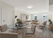Thumbnail 18 of 22 - A modern dining room with a glass table and chairs.