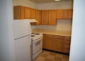 Thumbnail 8 of 13 - Kitchen with a white refrigerator and a white stove top oven.