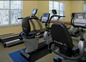 Thumbnail 9 of 15 - a room with a row of exercise bikes in front of a window