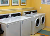Thumbnail 12 of 14 - On-site laundry available at Spacious community room at Park View at Colonial Landing where senior residents gather for coffee, activities, and social events in a friendly, supportive environment.