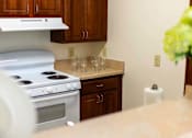 Thumbnail 10 of 14 - Modern, fully equipped kitchen with safety features in a senior apartment at Park View at Colonial Landing, a 62+ active adult community in Elkridge, MD.