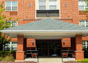 Thumbnail 8 of 14 - Exterior view of Park View at Colonial Landing, an award-winning senior apartment community in Elkridge, Maryland, surrounded by trees and featuring easy access to Route 1 and public transportation.