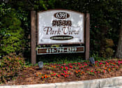 Thumbnail 7 of 14 - Exterior view of Park View at Colonial Landing, an award-winning senior apartment community in Elkridge, Maryland, surrounded by trees and featuring easy access to Route 1 and public transportation.