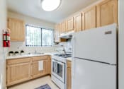Thumbnail 4 of 19 - Modern, fully equipped kitchen at Meadowbrook Run Apartments with energy-efficient appliances, sleek cabinetry, and updated finishes in a bright, open-concept layout.