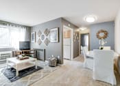 Thumbnail 2 of 19 - Spacious living room inside a Meadowbrook Run apartment home featuring large windows with natural light, hardwood-style flooring, and a neutral color palette for flexible furnishing options.