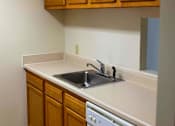 Thumbnail 8 of 9 - Well-appointed kitchen with ample cabinet space and modern appliances, part of a thoughtfully designed apartment at College Parkway Place, a family-friendly mid-rise community in historic Annapolis.