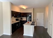 Thumbnail 7 of 30 - Sleek, modern kitchen with large island at Metro Heights apartment community near downtown Baltimore.