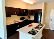 Thumbnail 8 of 30 - Sleek, modern kitchen with large island at Metro Heights apartment community near downtown Baltimore.