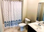 Thumbnail 12 of 30 - Bright bath with tub shower combo and upgraded finishes at Metro Heights in Baltimore.