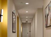 Thumbnail 14 of 30 - Well-lit hallways in apartment home entry from interior of the building at Metro Heights in Baltimore.