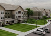 Thumbnail 2 of 4 - A large apartment complex with a grassy courtyard and parked cars.