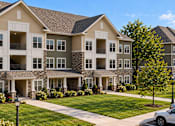Thumbnail 1 of 4 - A large, well-maintained apartment complex with multiple balconies and landscaped grounds.
