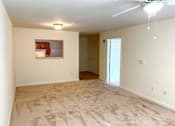 Thumbnail 11 of 15 - Spacious living room inside a 2-bedroom apartment at Park View at South Pantops, featuring wall-to-wall carpet, large windows with natural light, and individually controlled heating and air conditioning.