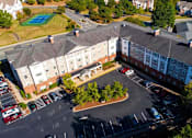 Thumbnail 2 of 15 - Exterior view of Park View at South Pantops, a senior apartment community in the Carriage Hill area near Charlottesville, featuring well-maintained buildings, landscaped grounds, and convenient on-site parking for adults age 62 and better.